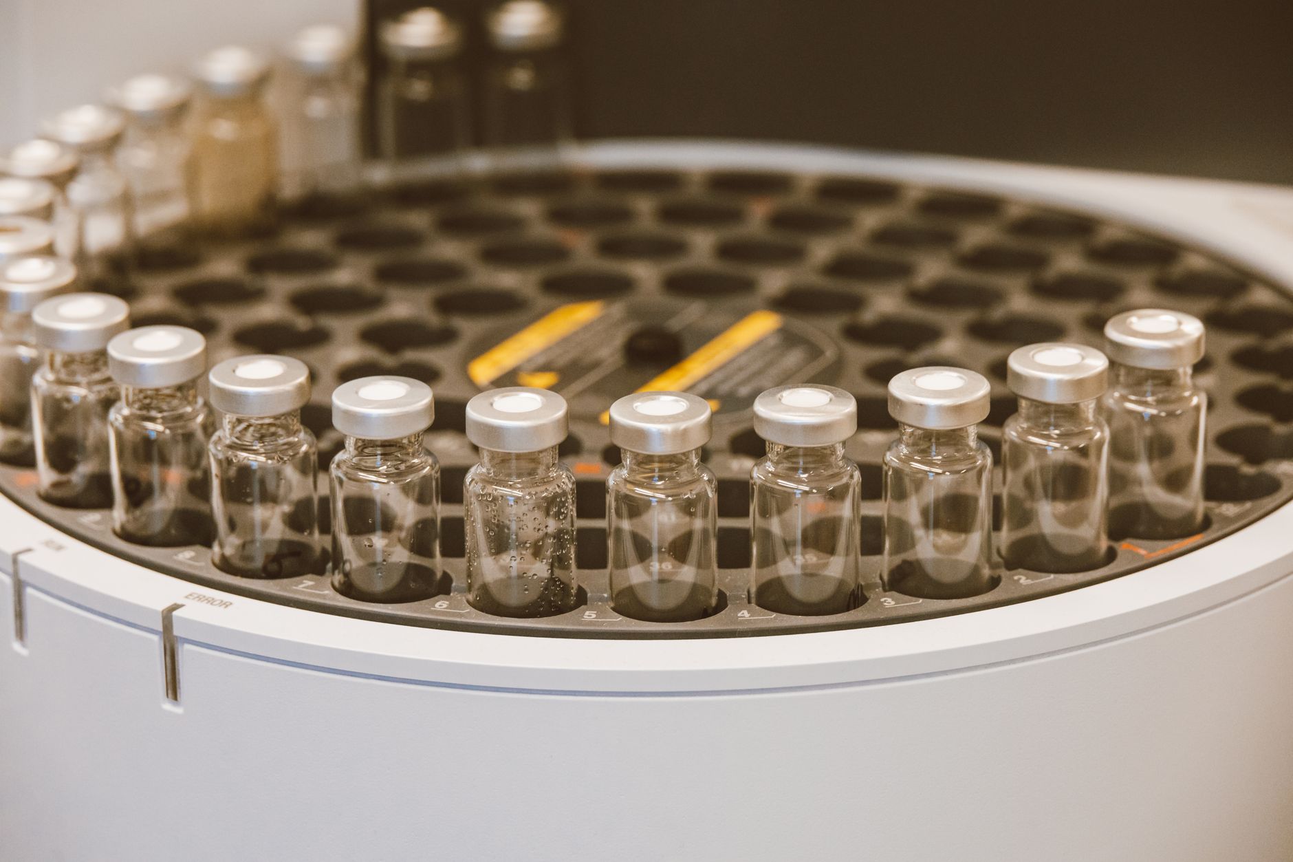 pharmaceutical research testing samples vials colorful fluorescent light microscopy analysis precision instruments