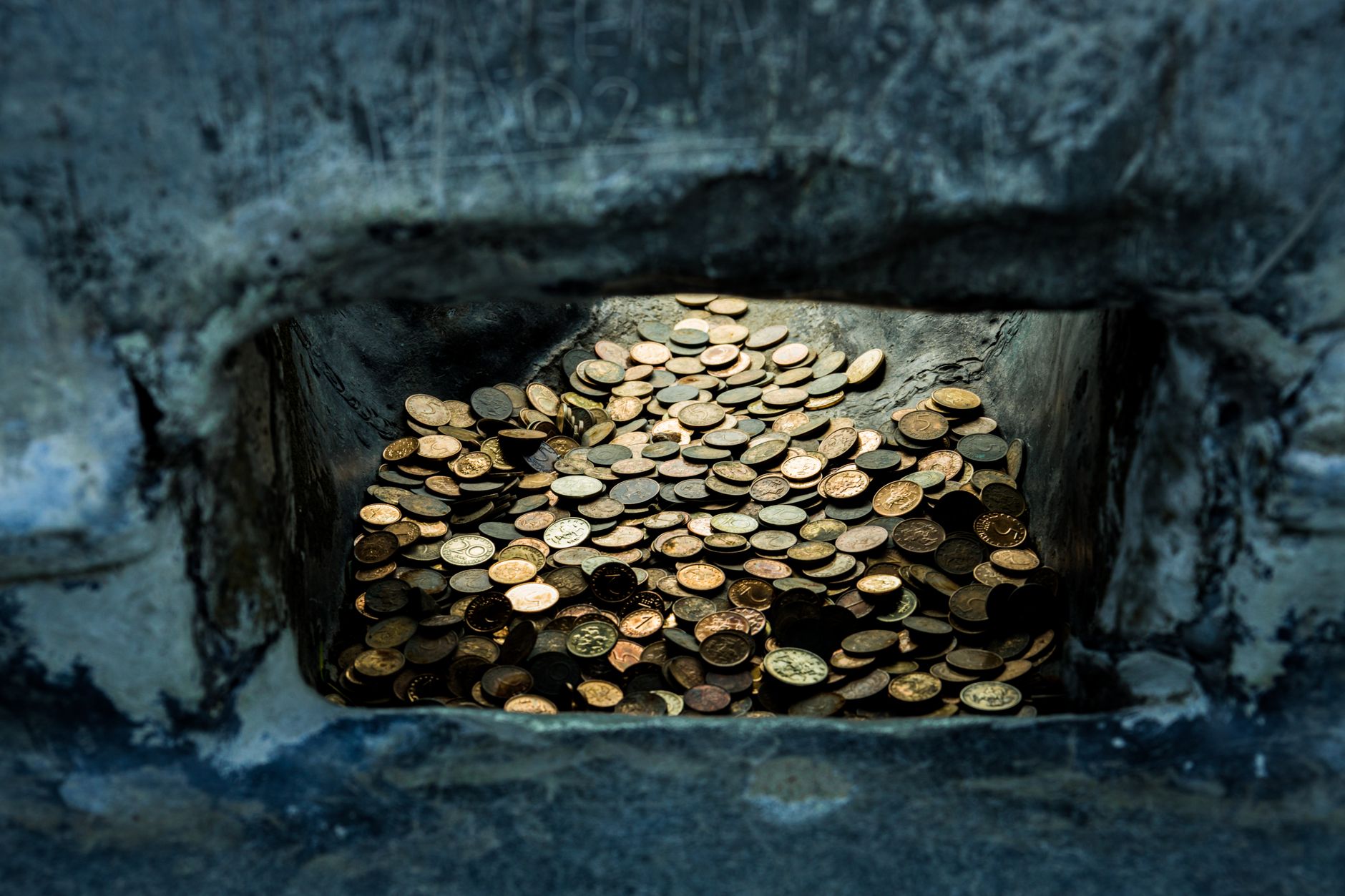ancient roman coins gold and silver scattered on earth at archaeological excavation site dramatic lighting
