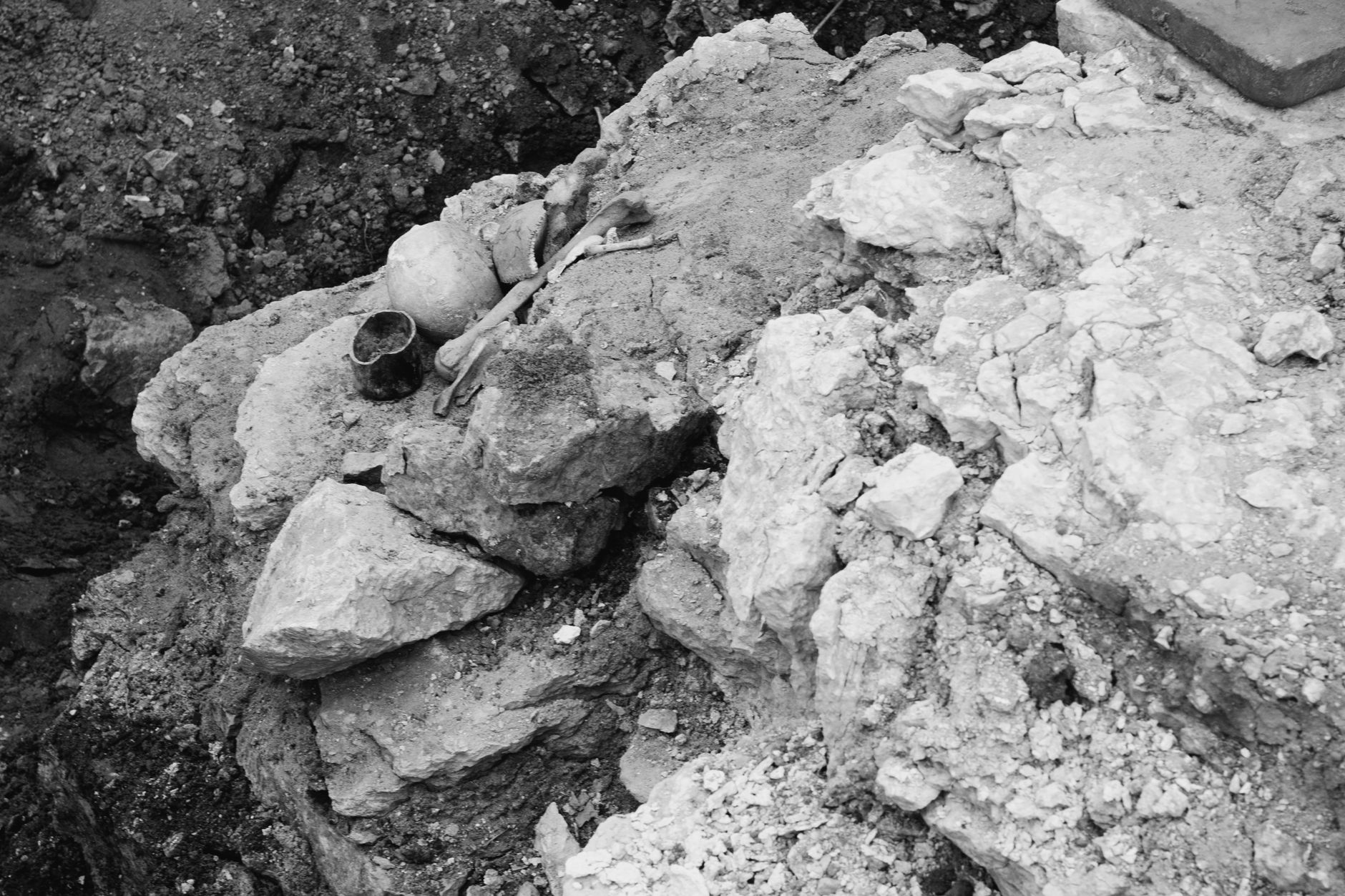 close-up of ancient Phoenician pottery shards and stone tools in excavation dirt